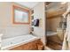 Luxurious bathroom with a soaking tub, glass-enclosed shower, tiled walls, and ample natural light at 960 Whispering Pines Ln, Breckenridge, CO 80424