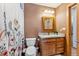 Cozy bathroom features decorative shower curtain, wood-framed mirror, and granite countertop at 960 Whispering Pines Ln, Breckenridge, CO 80424