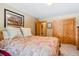 Comfortable bedroom with a quilted bed, closet, and decorative artwork at 960 Whispering Pines Ln, Breckenridge, CO 80424