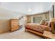 Cozy bedroom featuring light carpet, wooden furnishings, and a bright window view at 960 Whispering Pines Ln, Breckenridge, CO 80424