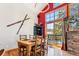 Open dining room with wooden table and chairs, and a large window with access to the outdoor deck at 960 Whispering Pines Ln, Breckenridge, CO 80424