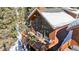 Stunning exterior showcasing an expansive deck with a stone fireplace perfect for outdoor gatherings at 960 Whispering Pines Ln, Breckenridge, CO 80424