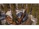 Stunning two-story cabin-style home with snow-covered roof nestled among evergreen trees at 960 Whispering Pines Ln, Breckenridge, CO 80424
