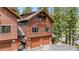 Exterior angle revealing the home's multi-car garage and additional exterior details at 960 Whispering Pines Ln, Breckenridge, CO 80424