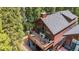 Stunning home exterior featuring a spacious deck with a fireplace and outdoor seating at 960 Whispering Pines Ln, Breckenridge, CO 80424