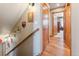 Hallway features wooden floors, decorative wall hangings, and arched doorway at 960 Whispering Pines Ln, Breckenridge, CO 80424