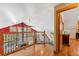 Upstairs hallway with hardwood floors overlooking the living room, natural light, and stairs to a lower level at 960 Whispering Pines Ln, Breckenridge, CO 80424