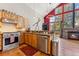 Well-lit kitchen with stainless steel appliances, wood cabinets, and stone countertops flowing into the living area with fireplace at 960 Whispering Pines Ln, Breckenridge, CO 80424
