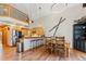 Open kitchen and dining area, featuring a breakfast bar, stainless steel appliances, and stylish pendant lighting fixtures at 960 Whispering Pines Ln, Breckenridge, CO 80424