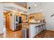 Well-equipped kitchen featuring stainless steel appliances, granite countertops, and a breakfast bar, perfect for casual dining at 960 Whispering Pines Ln, Breckenridge, CO 80424