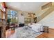 Spacious living room with a fireplace, large windows, and views of the natural surroundings at 960 Whispering Pines Ln, Breckenridge, CO 80424