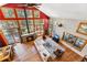 Open-concept living room with a stone fireplace, large windows, wood floors, and comfortable seating at 960 Whispering Pines Ln, Breckenridge, CO 80424