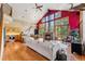 Open-concept living space with a fireplace, dining area, and kitchen, perfect for entertaining at 960 Whispering Pines Ln, Breckenridge, CO 80424