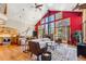 Open-concept living space featuring vaulted ceilings, natural light, modern furnishings, and seamless flow into the kitchen at 960 Whispering Pines Ln, Breckenridge, CO 80424