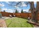 Backyard with green lawn, privacy fence, and outdoor seating area at 19411 E Milan Cir, Aurora, CO 80013