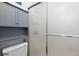 Bathroom with shower doors and gray storage cabinet above the toilet at 19411 E Milan Cir, Aurora, CO 80013