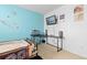 A light-filled bedroom featuring a desk area with an aquarium and accent wall at 19411 E Milan Cir, Aurora, CO 80013