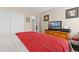 Bedroom with closet, doorway, and modern entertainment center at 19411 E Milan Cir, Aurora, CO 80013