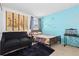 Bedroom with a black couch, colorful wall art and an aquarium on a table at 19411 E Milan Cir, Aurora, CO 80013