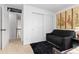 A comfortable bedroom with a black sofa, oriental wall art, and closet doors at 19411 E Milan Cir, Aurora, CO 80013