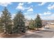 Street view of property with mature evergreen trees in the front yard at 19411 E Milan Cir, Aurora, CO 80013