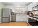 Cozy kitchen with stainless steel appliances and mosaic tile backsplash at 19411 E Milan Cir, Aurora, CO 80013
