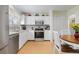 Bright kitchen with white cabinetry and a breakfast table near the closet at 19411 E Milan Cir, Aurora, CO 80013