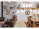 Cozy living room with a fireplace, adjacent to a dining area with decorative wall art at 19411 E Milan Cir, Aurora, CO 80013