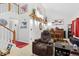 Comfortable living room showcasing leather seating, fireplace, dining area, and an open staircase at 19411 E Milan Cir, Aurora, CO 80013