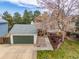 Attractive home boasts a spacious driveway, well-manicured lawn, and mature trees at 6282 Yank Ct, Arvada, CO 80004