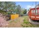 Landscaped backyard featuring a deck and mature trees at 6282 Yank Ct, Arvada, CO 80004