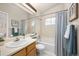 Well lit bathroom with a shower/tub combination and a vanity with a sink, offering a relaxing space at 6282 Yank Ct, Arvada, CO 80004