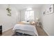 Cozy bedroom with neutral tones, a large window, and stylish decor create a peaceful retreat at 6282 Yank Ct, Arvada, CO 80004