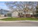Charming home featuring an attached garage, well-maintained lawn, and mature trees at 6282 Yank Ct, Arvada, CO 80004