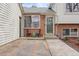 Inviting home featuring a brick entryway and a cozy front porch seating area at 6282 Yank Ct, Arvada, CO 80004