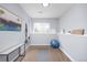 A home gym with fitness equipment, natural light, carpeted floors, and a mirror to help maintain an active lifestyle at 6282 Yank Ct, Arvada, CO 80004
