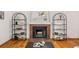 Inviting living room featuring a brick fireplace and decorative shelving units at 6282 Yank Ct, Arvada, CO 80004