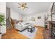Inviting living room featuring hardwood floors and a cozy brick fireplace at 6282 Yank Ct, Arvada, CO 80004