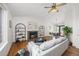 Bright living room with a brick fireplace, hardwood floors, and a vaulted ceiling at 6282 Yank Ct, Arvada, CO 80004