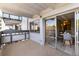 Open-air balcony with dining table and sliding glass door leading to living area at 555 E 10Th Ave # 206, Denver, CO 80203