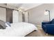 Bright bedroom with a whitewashed wood accent wall and stylish sliding door at 555 E 10Th Ave # 206, Denver, CO 80203