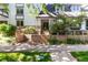 Apartment complex exterior with well maintained landscaping, brick accents, and mature trees at 555 E 10Th Ave # 206, Denver, CO 80203
