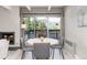 Well-lit dining area with wood table, seating, fireplace, and outdoor balcony access at 555 E 10Th Ave # 206, Denver, CO 80203