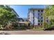 Exterior building view with well-maintained landscaping, brick accents, and tree lined street at 555 E 10Th Ave # 206, Denver, CO 80203