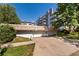 Multi-story building with garage access, sidewalks, mature trees, and well-maintained green spaces at 555 E 10Th Ave # 206, Denver, CO 80203