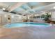 Bright indoor pool features ample lighting, surrounding plants, and outdoor seating by the window at 555 E 10Th Ave # 206, Denver, CO 80203