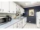 Functional kitchen with white cabinets, modern appliances, and plenty of counter space at 555 E 10Th Ave # 206, Denver, CO 80203