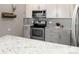 Updated kitchen showcasing stainless steel appliances and granite countertops at 555 E 10Th Ave # 206, Denver, CO 80203