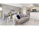 Bright living room featuring neutral tones, plush seating, and an open layout to the dining area at 555 E 10Th Ave # 206, Denver, CO 80203