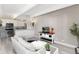 Open living space with modern decor, white kitchen, stylish tv stand, and light-filled atmosphere at 555 E 10Th Ave # 206, Denver, CO 80203